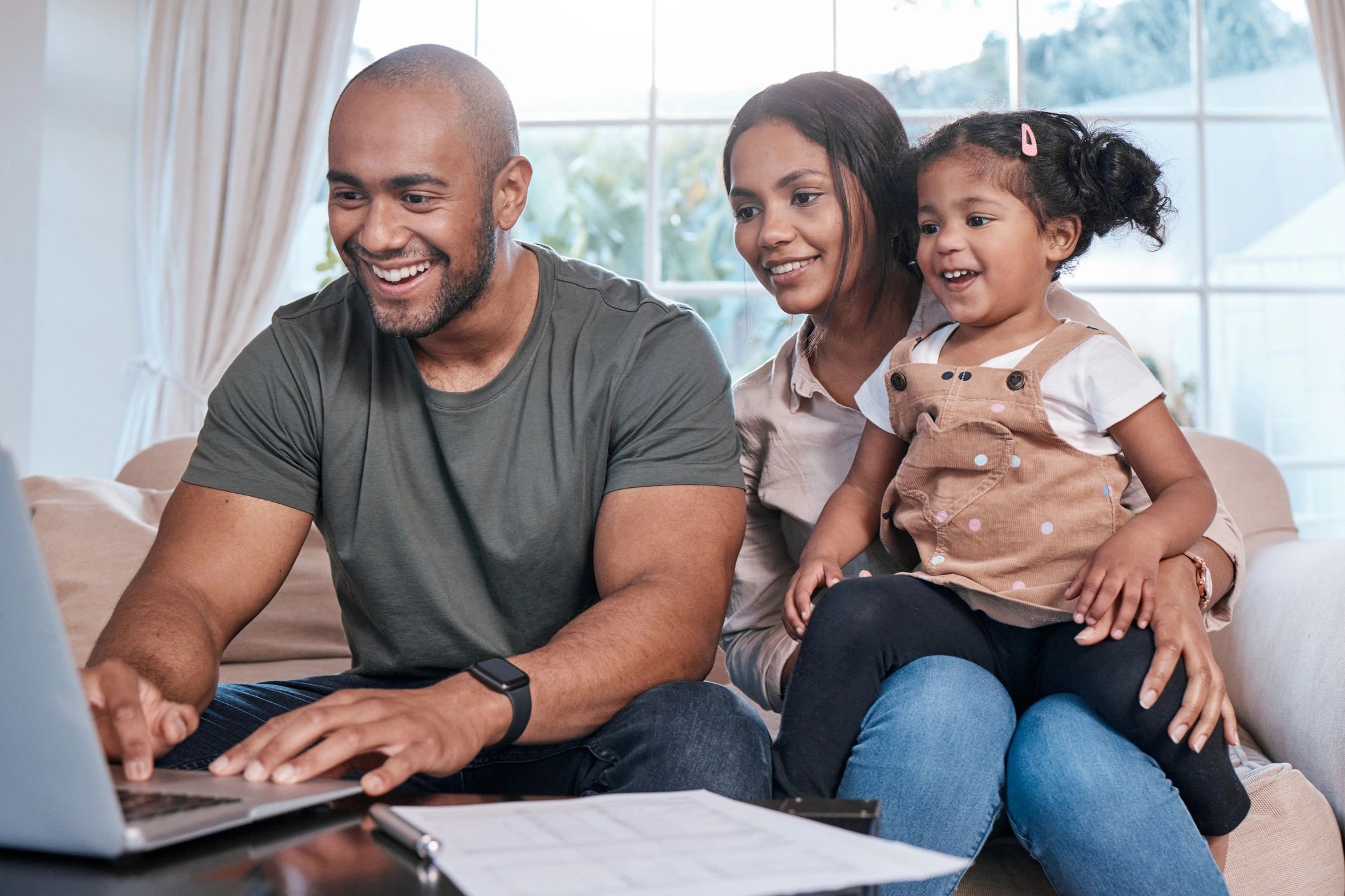 Couple and child reviewing plans together at home