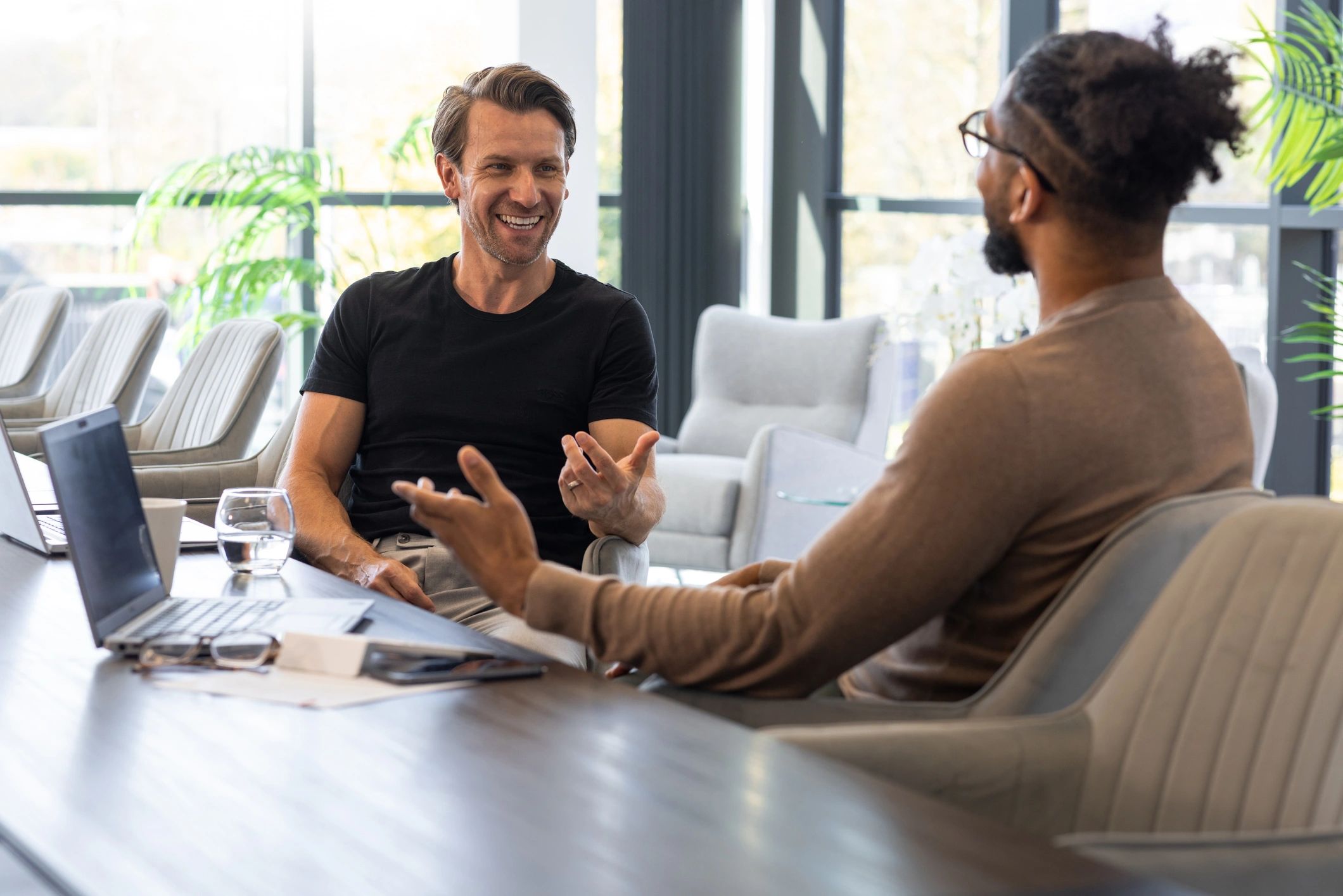 Two professionals discussing plans in a conference room